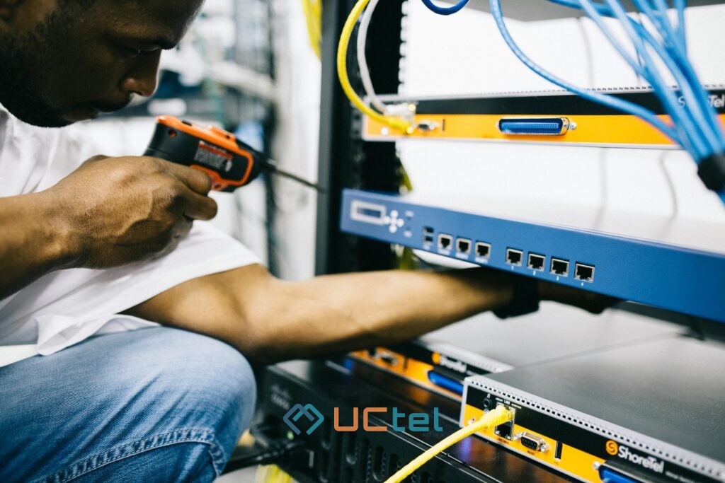 Signal booster for commercial property and industrial facilities 5 Technician inspecting mobile signal booster equipment in a telecom cabinet